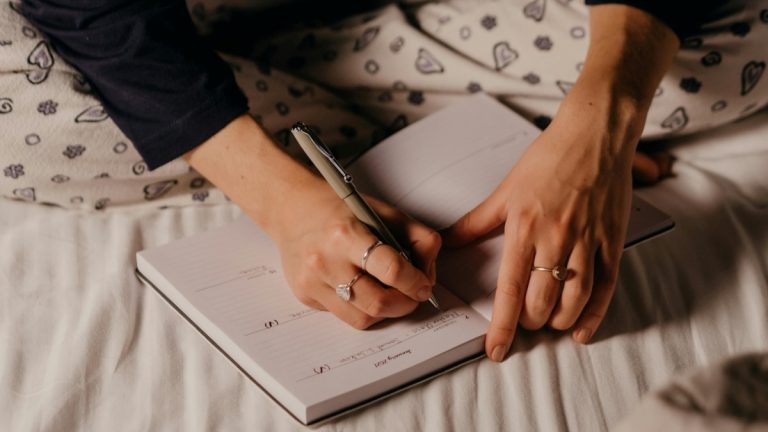 writing a sleep journal in bed