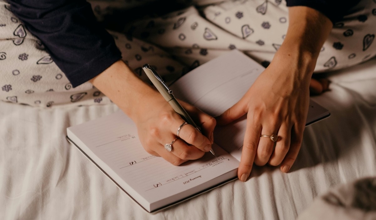 writing a sleep journal in bed